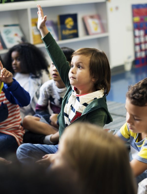 Kindergarten students sitting on the floor