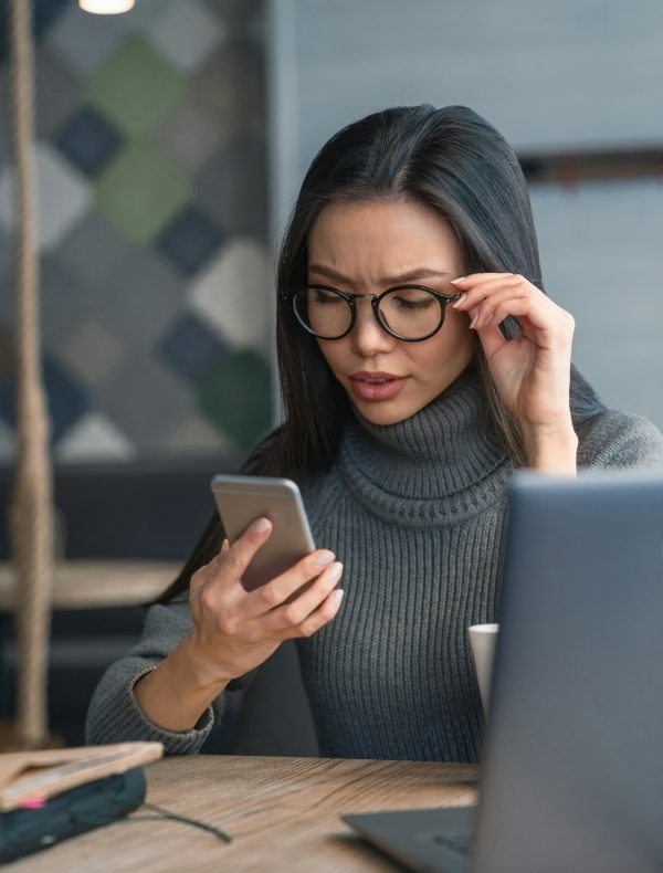 Vertical shot of working process. Young business woman with full concentration